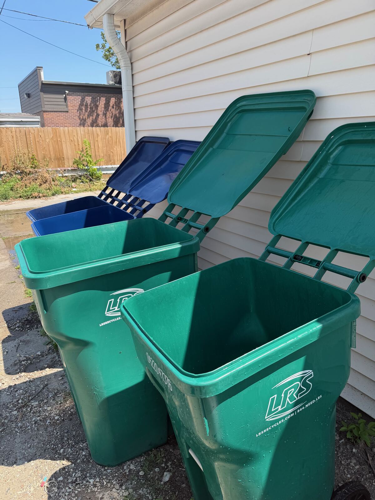 Freshly pressure washed trash and recycling bins